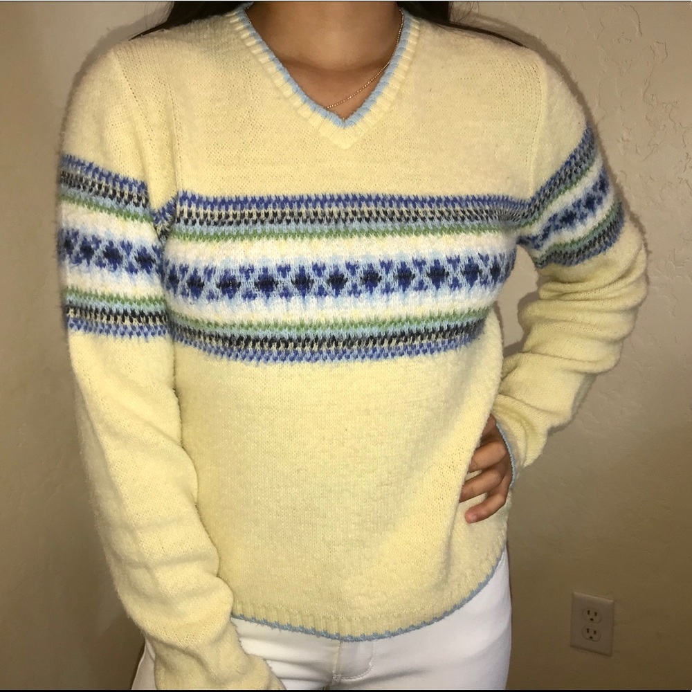 light yellow fuzzy sweater with blue details
